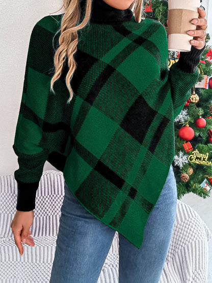 A person adorned in a Trendsi Plaid Turtleneck Batwing Sleeve Sweater, featuring a green and black design crafted from 100% acrylic, holds a coffee cup while standing before a decorated Christmas tree. Exuding a basic style with their long, wavy hair and blue jeans, they achieve an effortlessly chic look. Sweater care instructions suggest machine washing it in cold water.