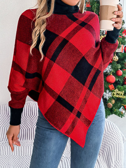 A person dressed in a red and black Trendsi Plaid Turtleneck Batwing Sleeve Sweater made from imported acrylic material, paired with jeans, holds a takeaway coffee cup. In the background stands a Christmas tree adorned with lights and ornaments, including a visible "Merry Christmas" ornament. The cozy sweater is conveniently machine washable.