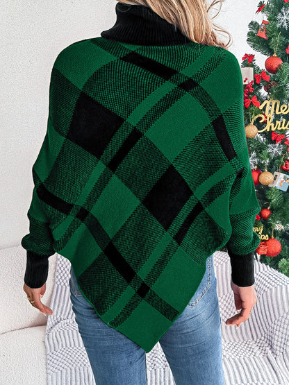 A person stands with their back to the camera, showcasing a Plaid Turtleneck Batwing Sleeve Sweater from Trendsi in green and black hues. They're wearing blue jeans, and a decorated Christmas tree in the background adds holiday cheer to their stylish ensemble.